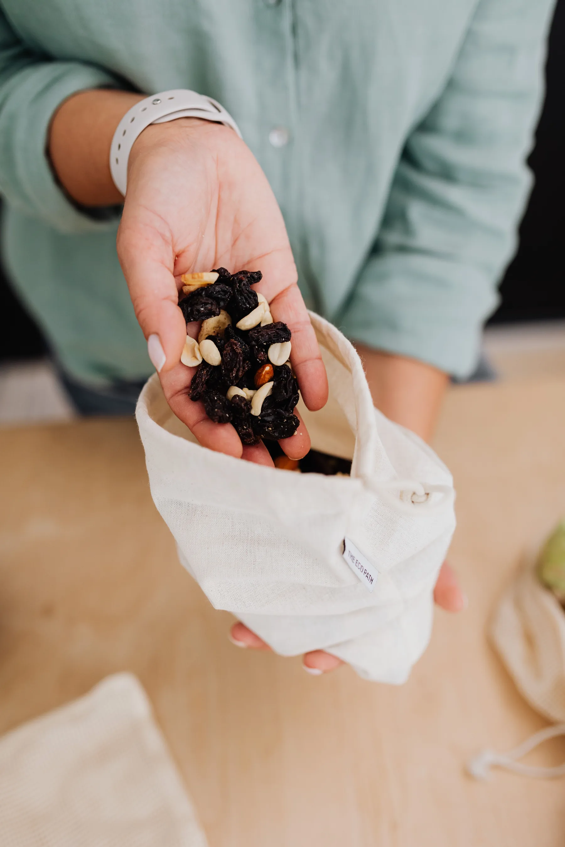Representative handful of dried fruit and nuts in a reusable bag